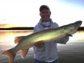 Steve's buddy Charlie Buhler with a nice early fall musky from shallow slop at sundown.