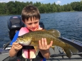 Ethan had a pretty good summer fishing for bass. Here he admires a smallmouth that he caught.