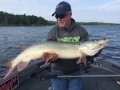 Instructor Kevin Schmidt admires a hefty musky while in Steve's boat at the 2017 University of Esox School on Lake of the Woods.