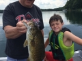 Steve with his grandson, Ethan, and a big smallmouth bass.